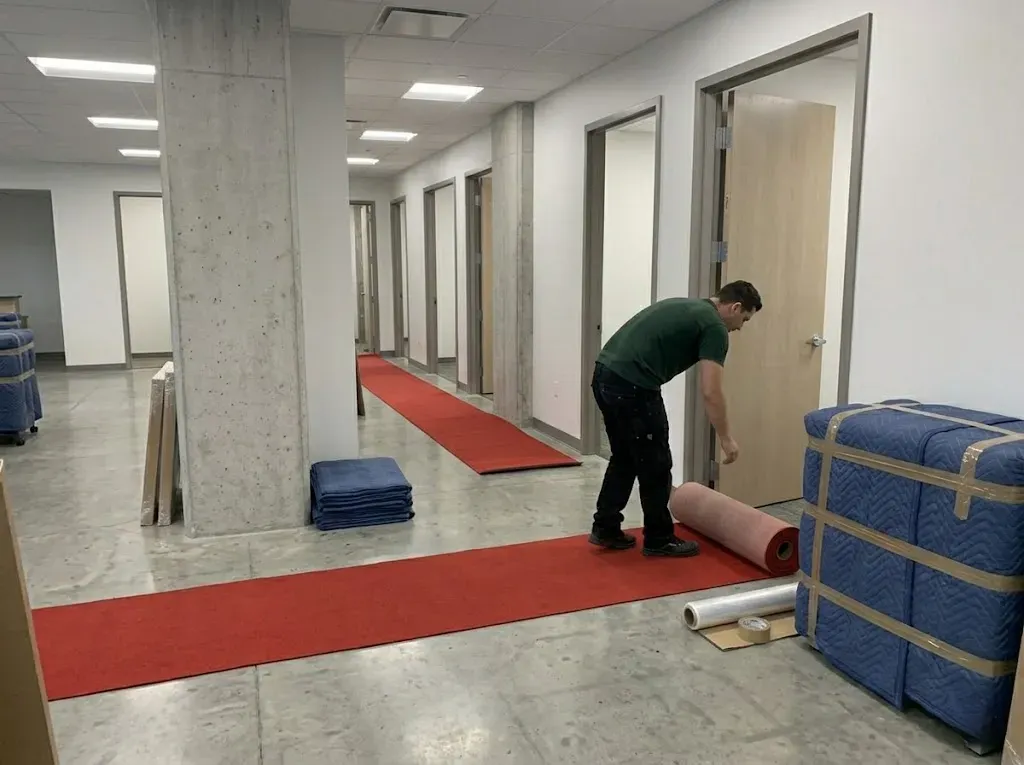 Technician deploying protective floor runners in a Richmond Hill office