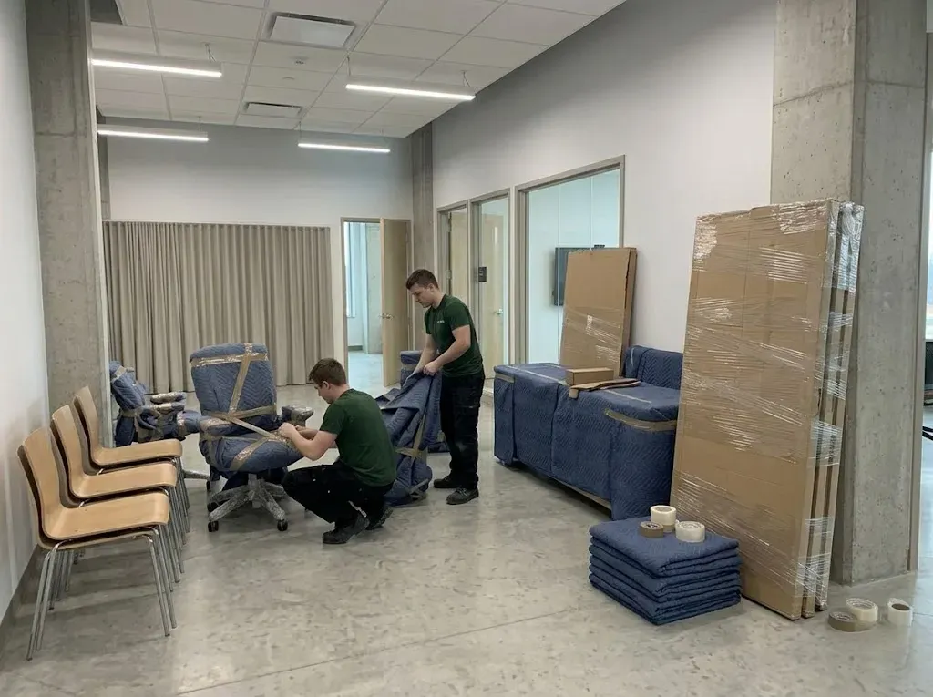 Two movers expertly wrapping items for transport in North York